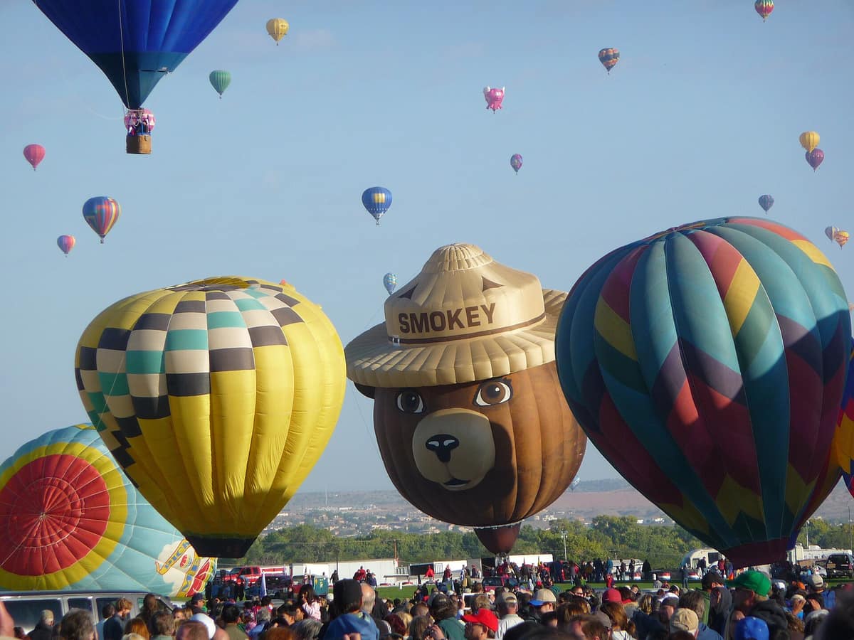 A Smokey Bear balloon and other balloons before launch at the Fiesta