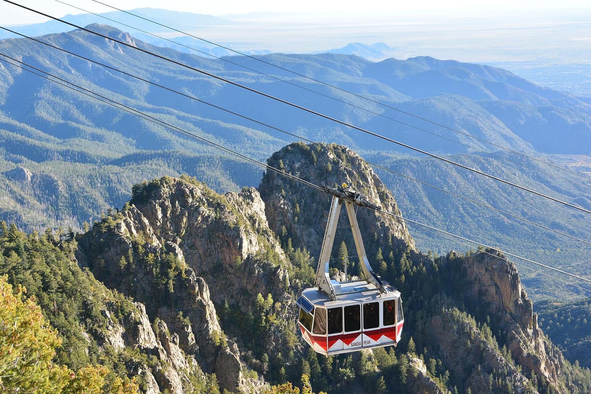 A Sandia Peak Tramway car above the rocky face of the Sandia Mountains
