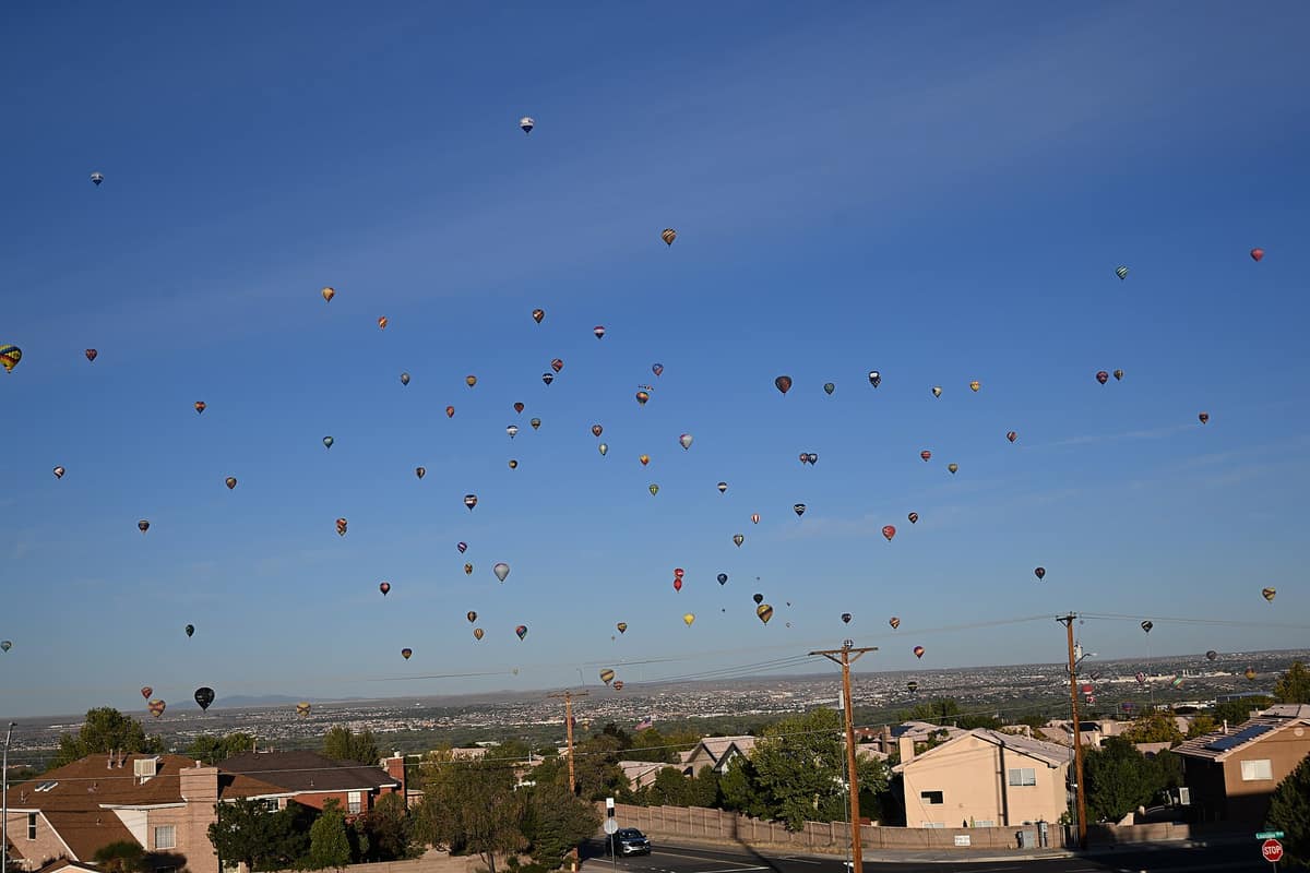 Hot-air balloons floating over Albuquerque neighborhoods
